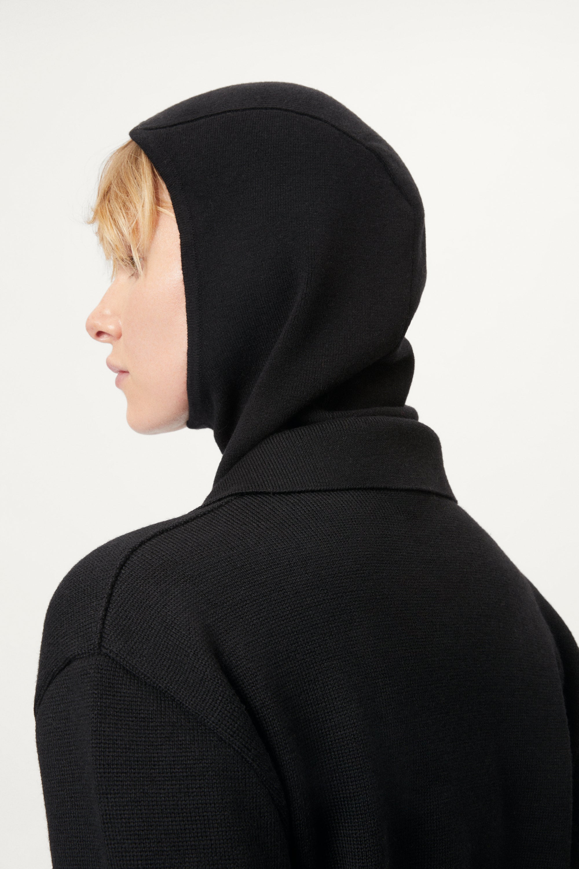 woman wearing a black ultrasoft miniclava against a white background