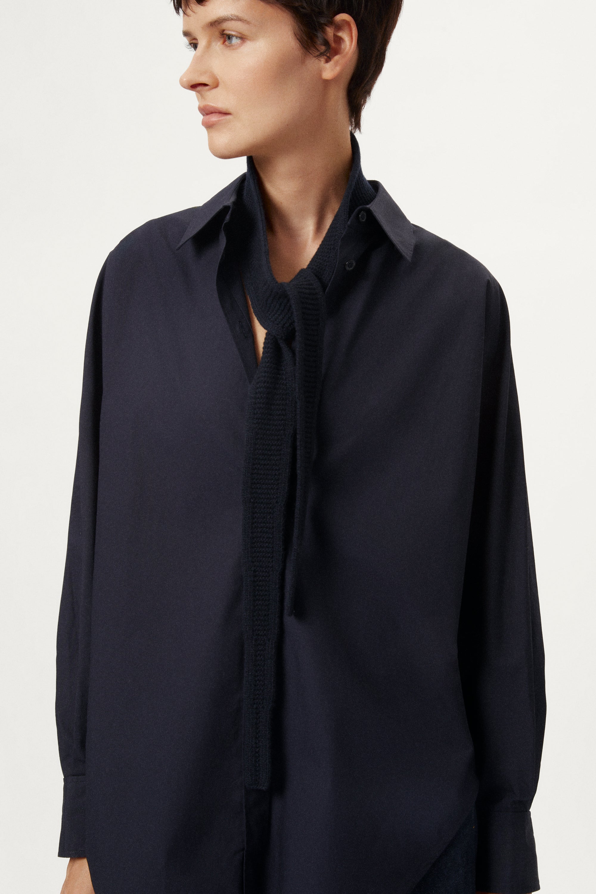 Person wearing a blue navy Woolen Mini Scarf