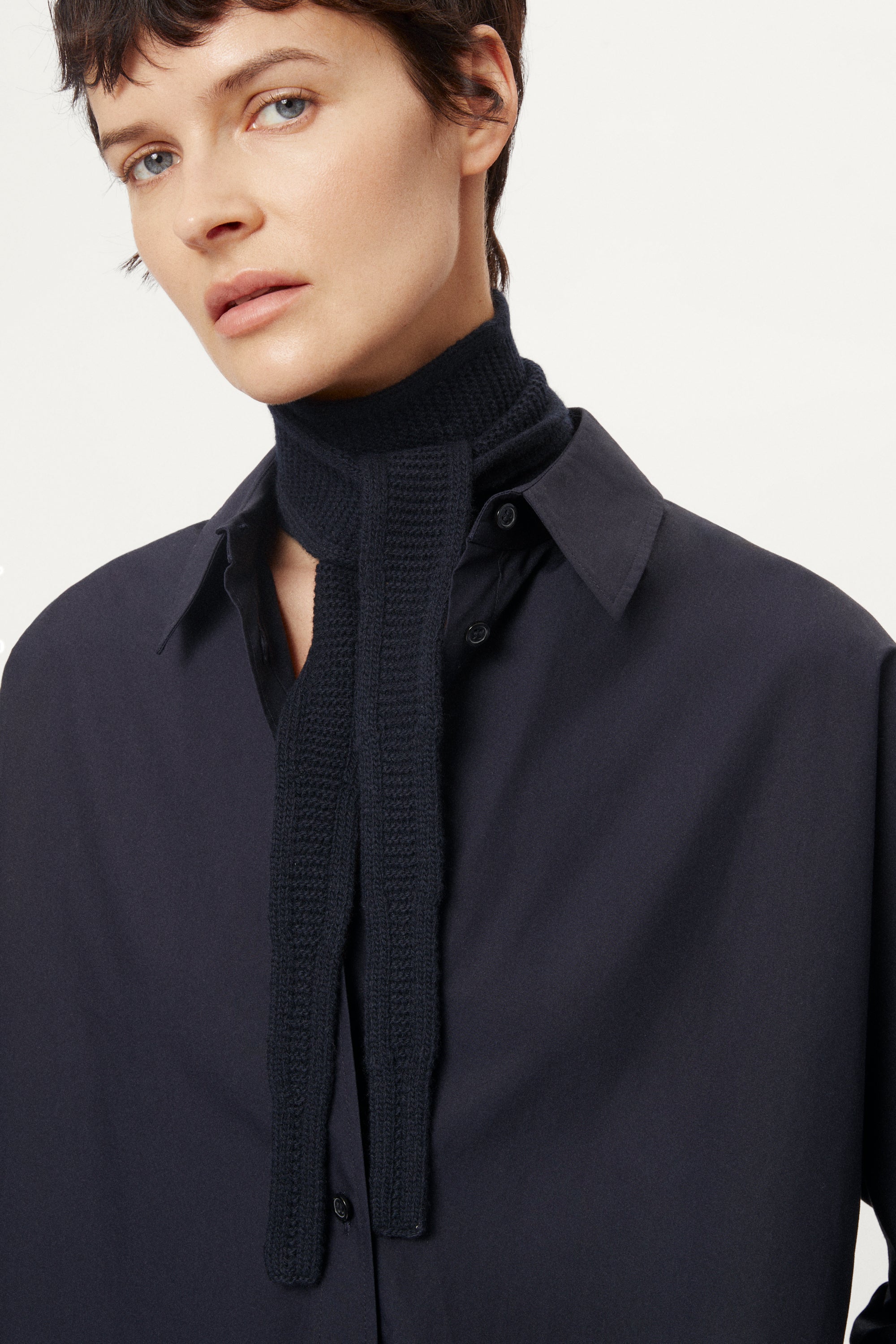 Person wearing a blue navy Woolen Mini Scarf