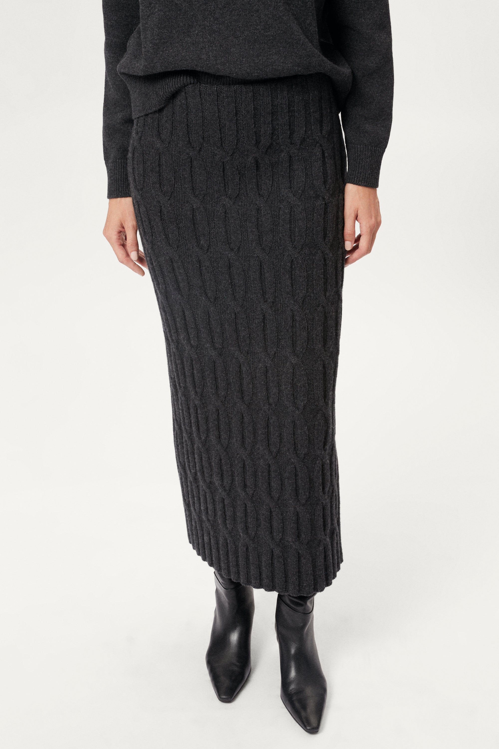 woman wearing a dark grey Woolen Cable knit skirt