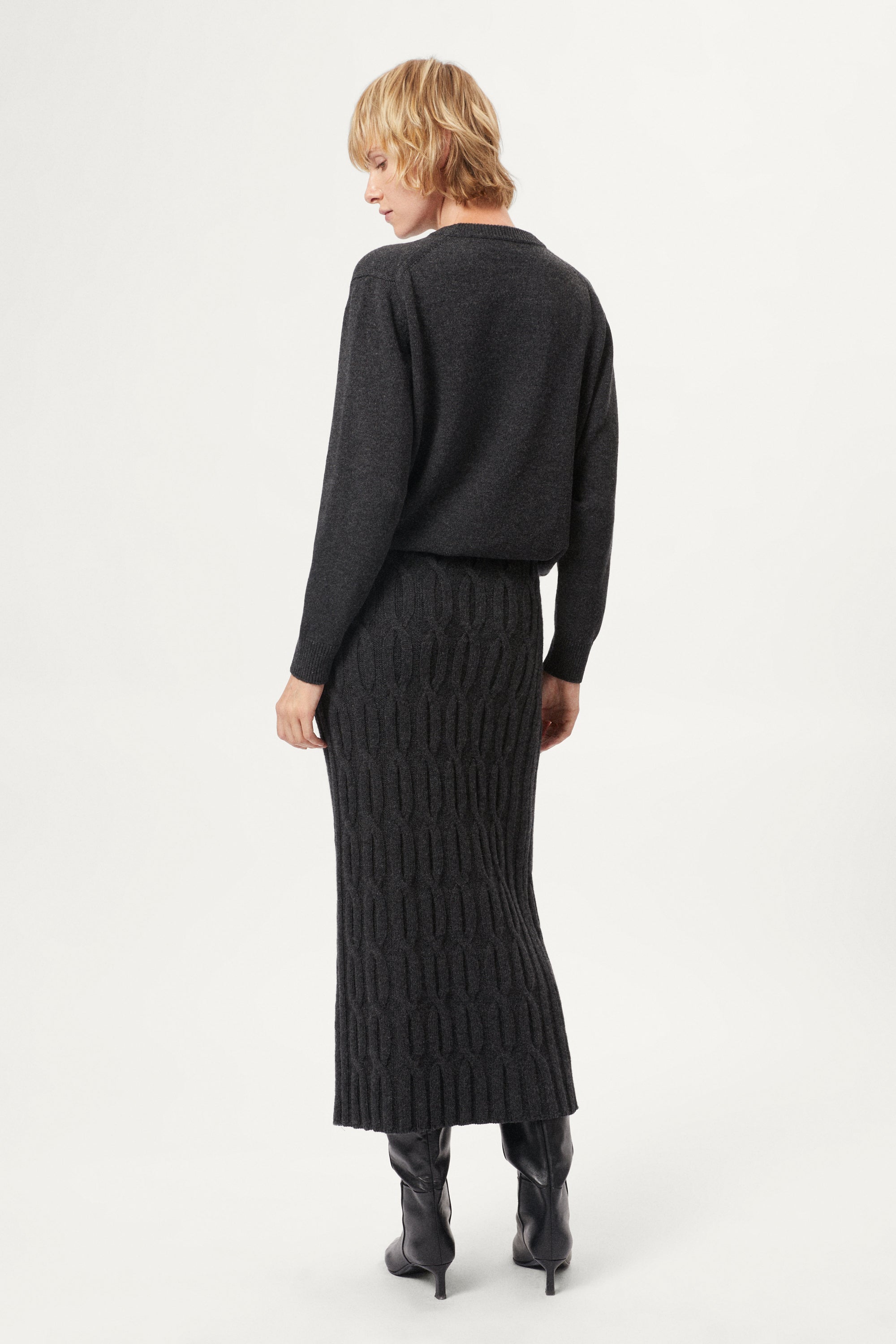woman wearing a dark grey Woolen Cable knit skirt