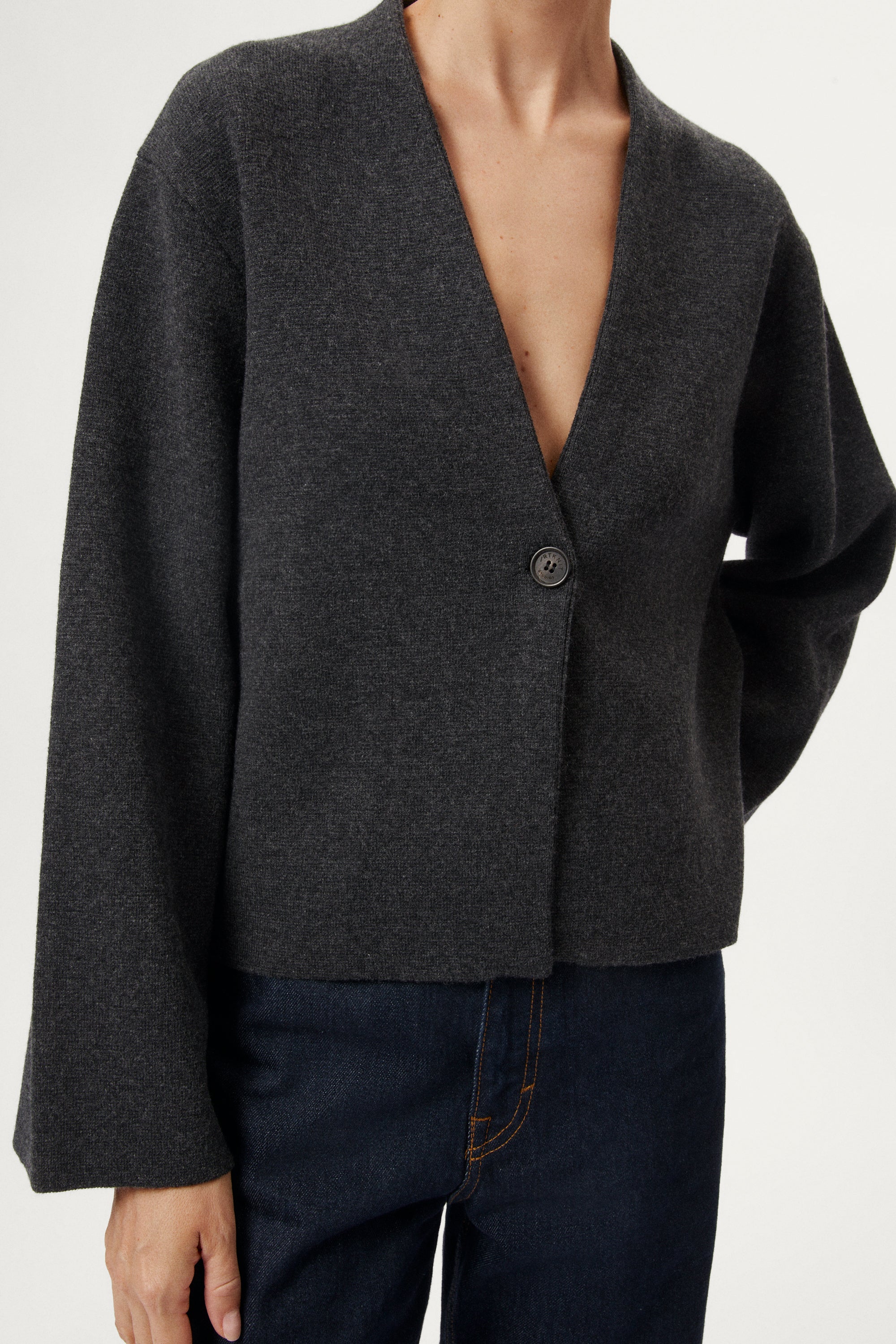woman wearing a woolen dark gray cardigan