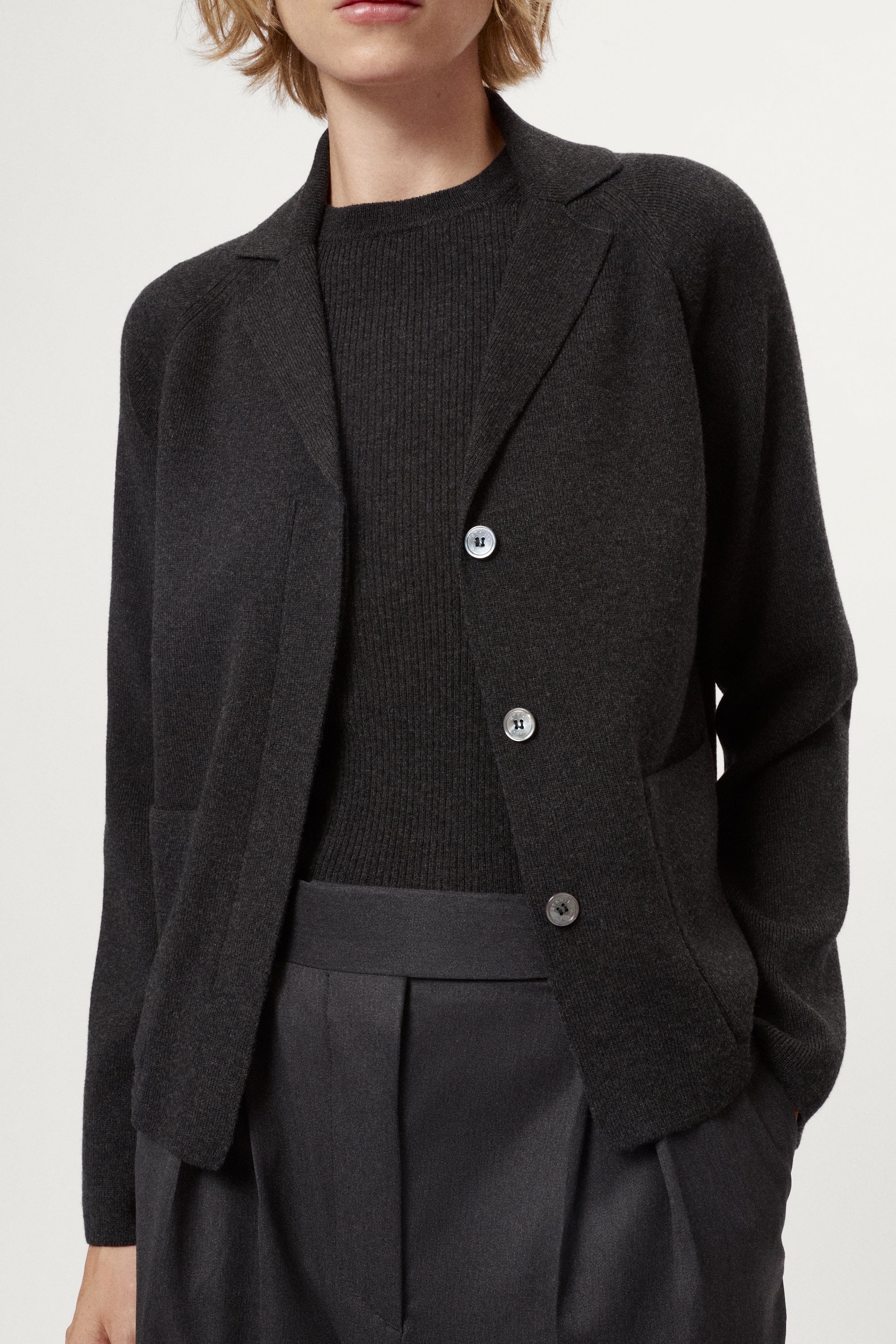 Woman wearing a grey Wool Rever Jacket on a white background