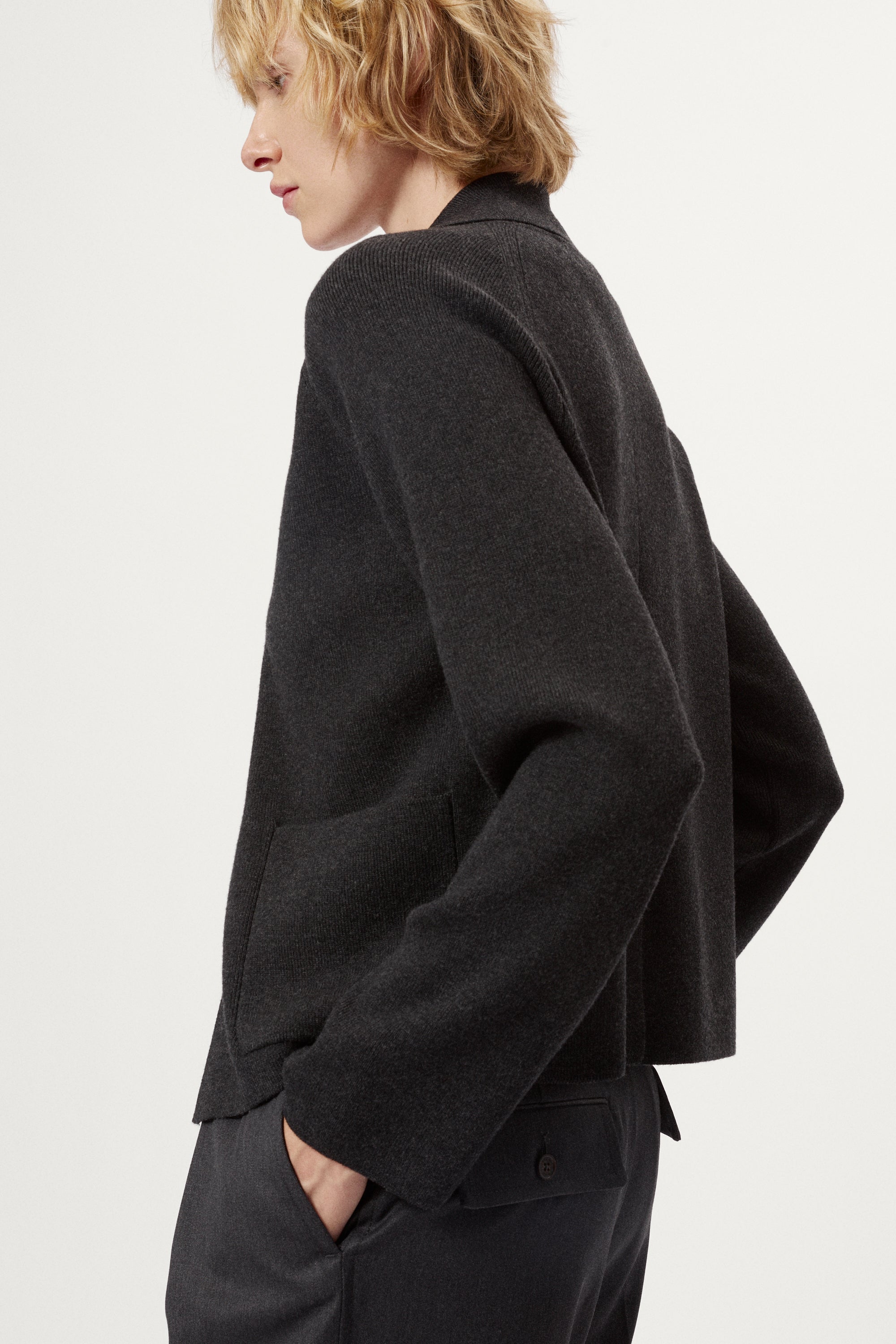 Woman wearing a grey Wool Rever Jacket on a white background