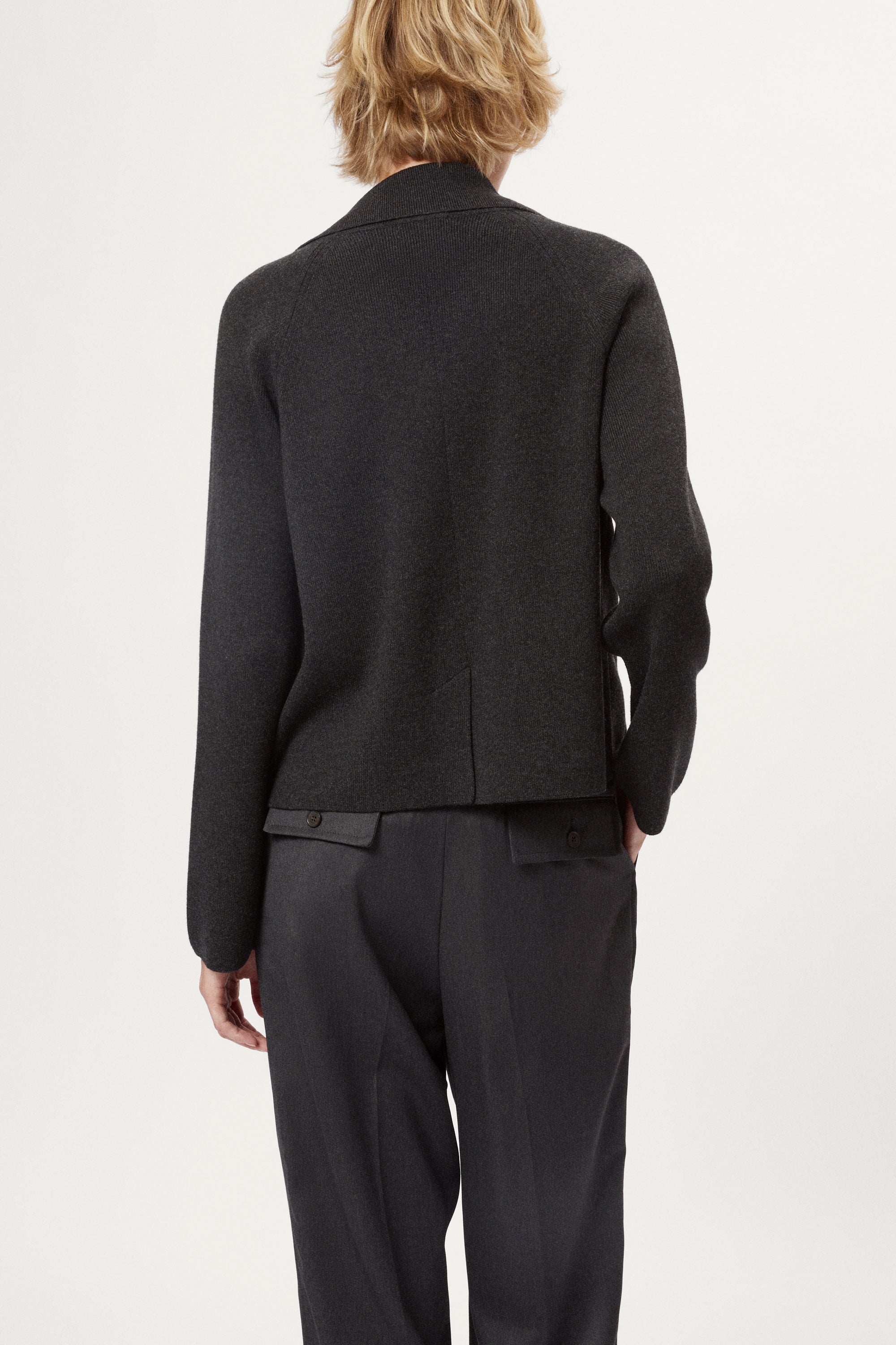 Woman wearing a grey Wool Rever Jacket on a white background