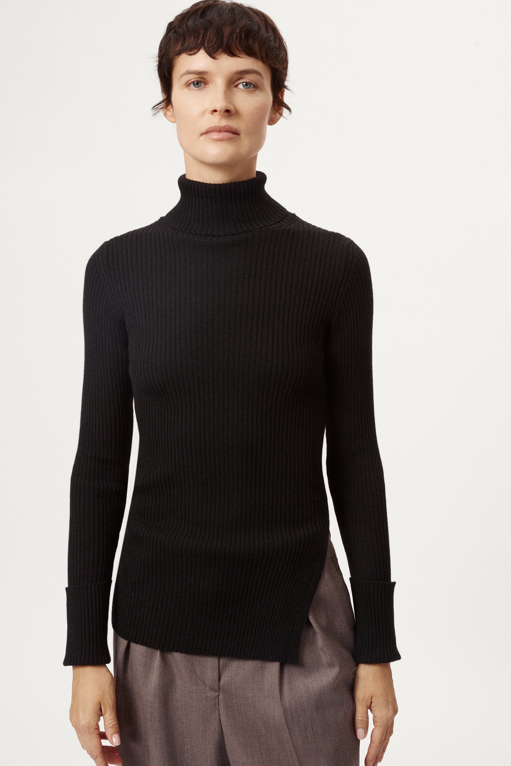 Person wearing a black turtleneck sweater on a white background
