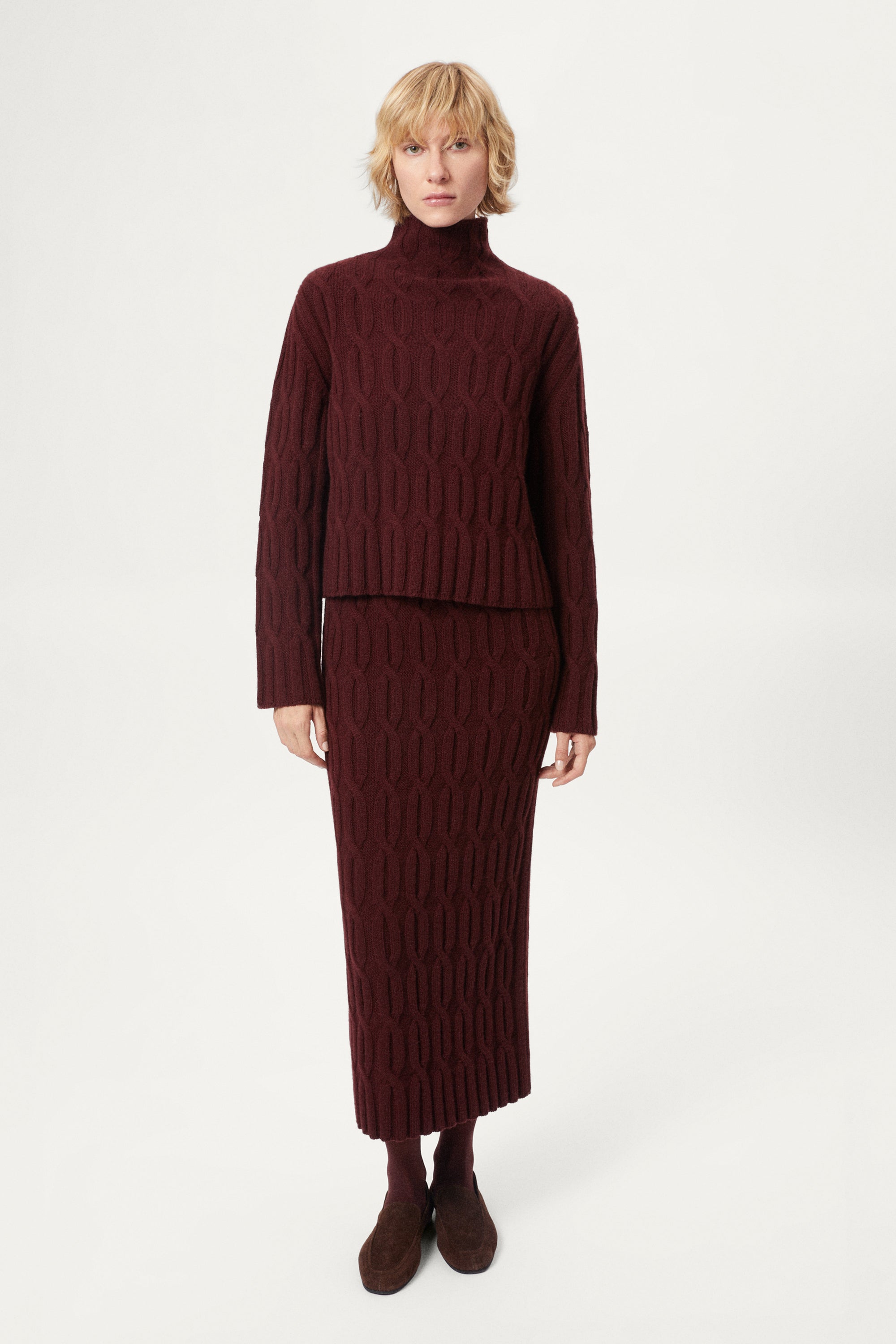 woman wearing a burgundy Woolen Cable knit skirt