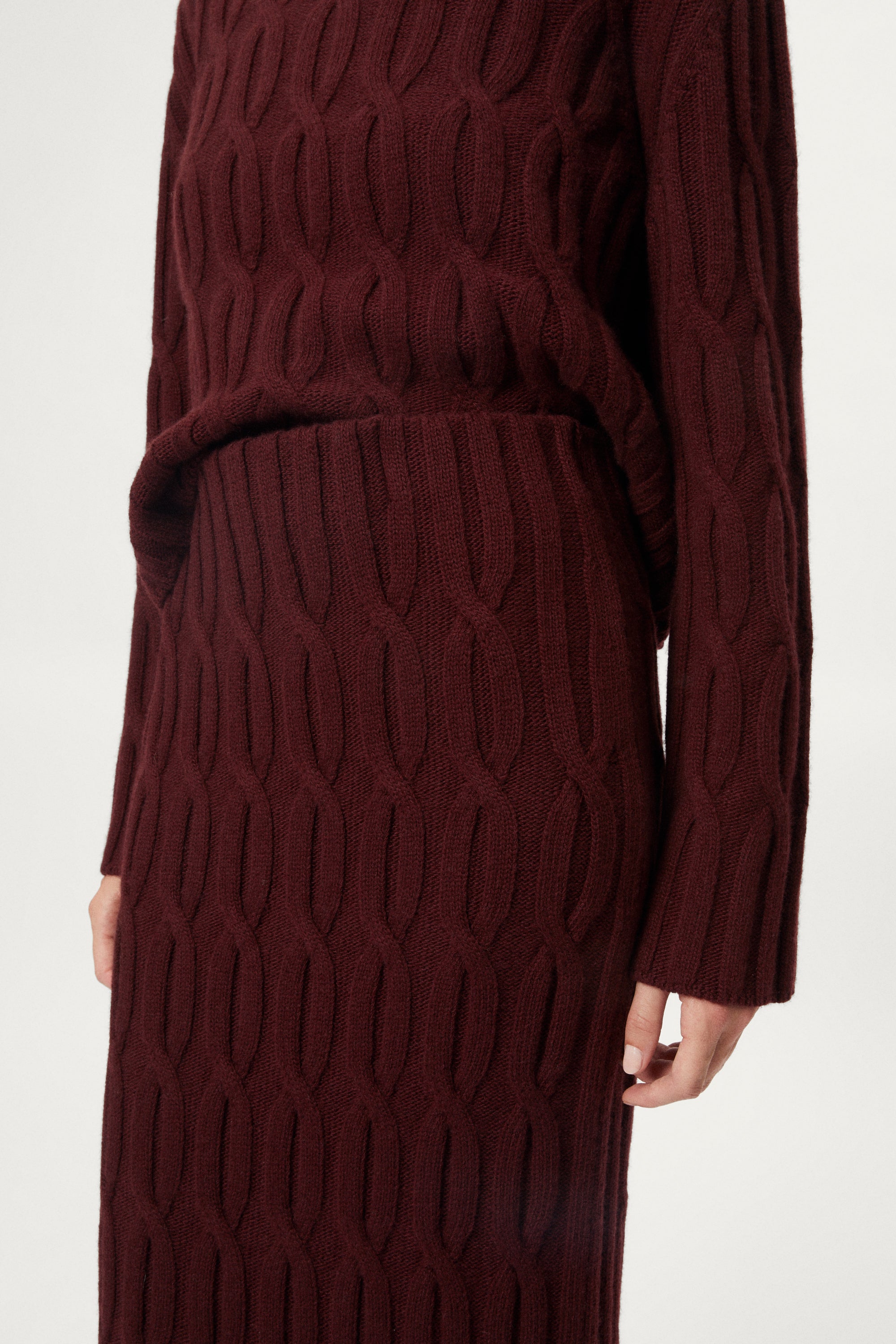woman wearing a burgundy Woolen Cable knit skirt
