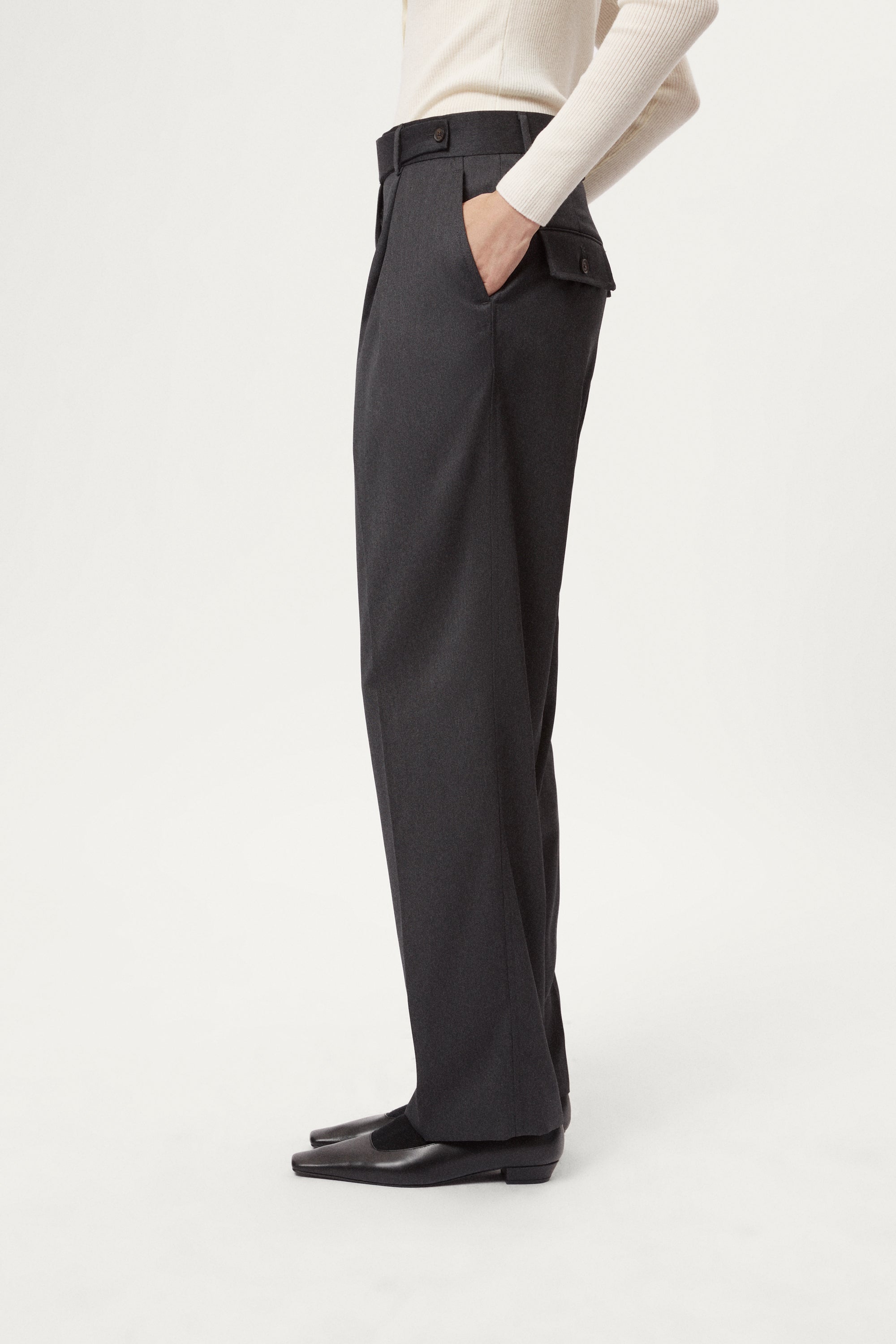 Dark gray pleated pants with a white background