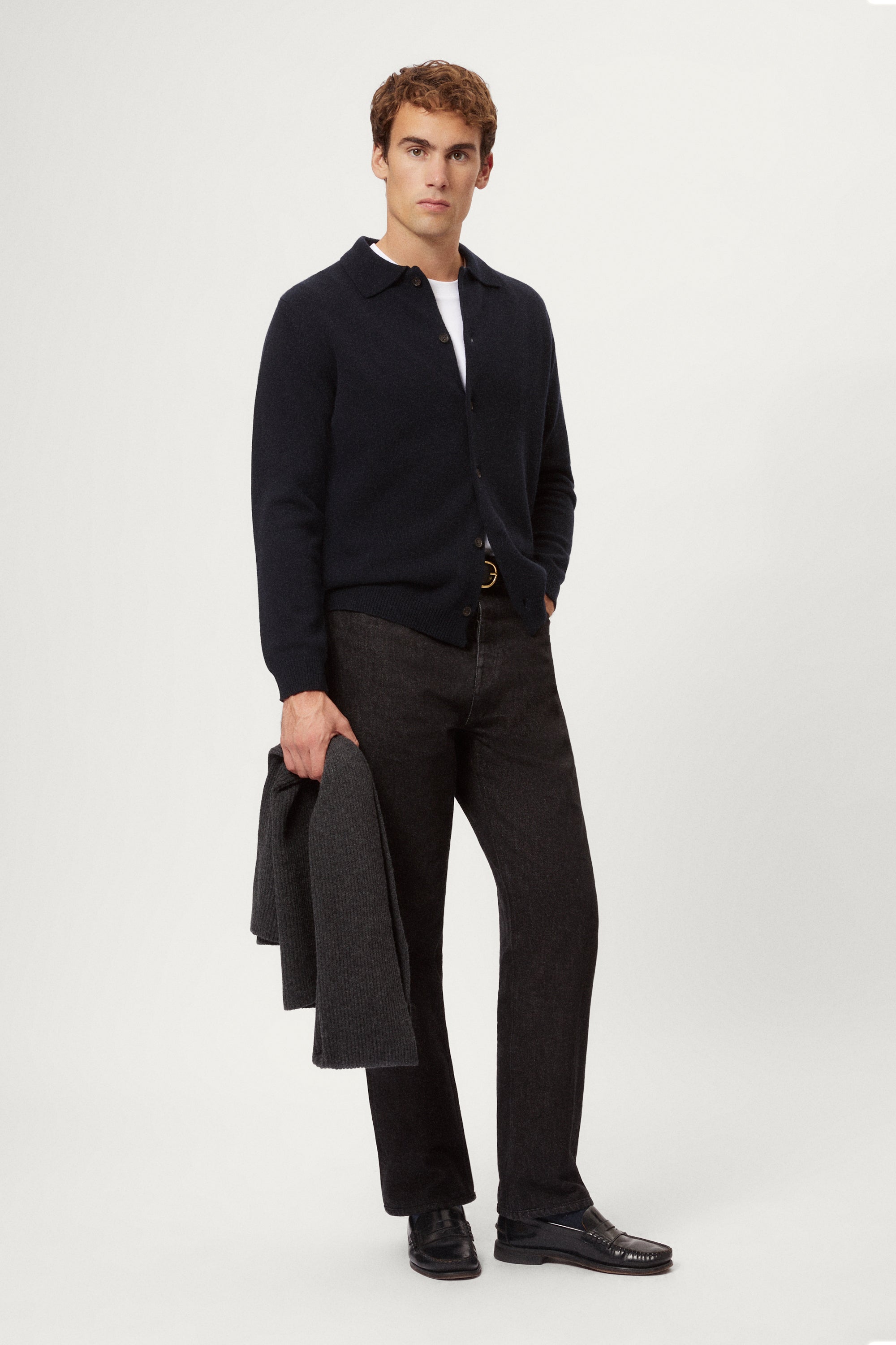 Man wearing a blue wool shirt over a white shirt with a plain background