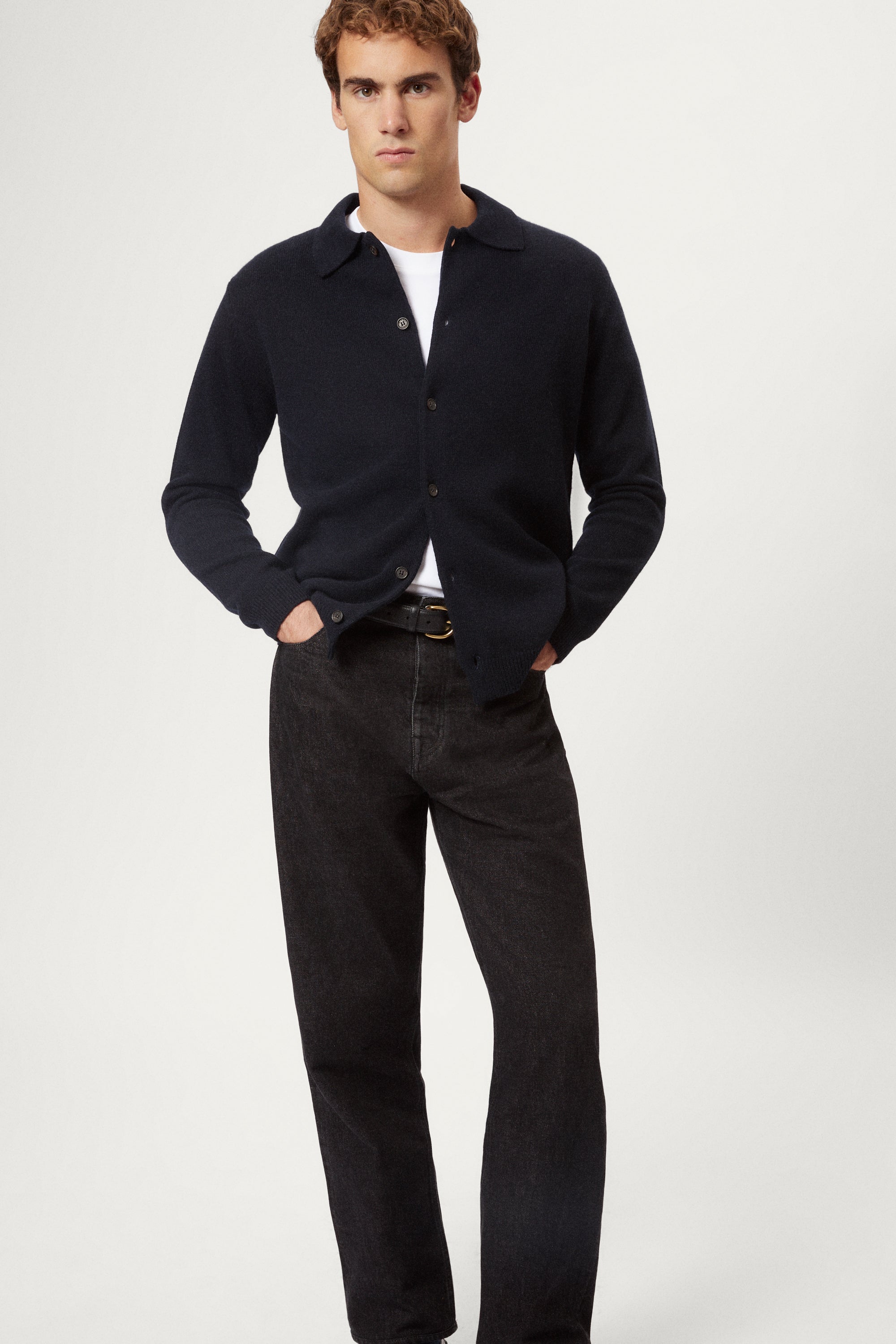 Man wearing a blue wool shirt over a white shirt with a plain background