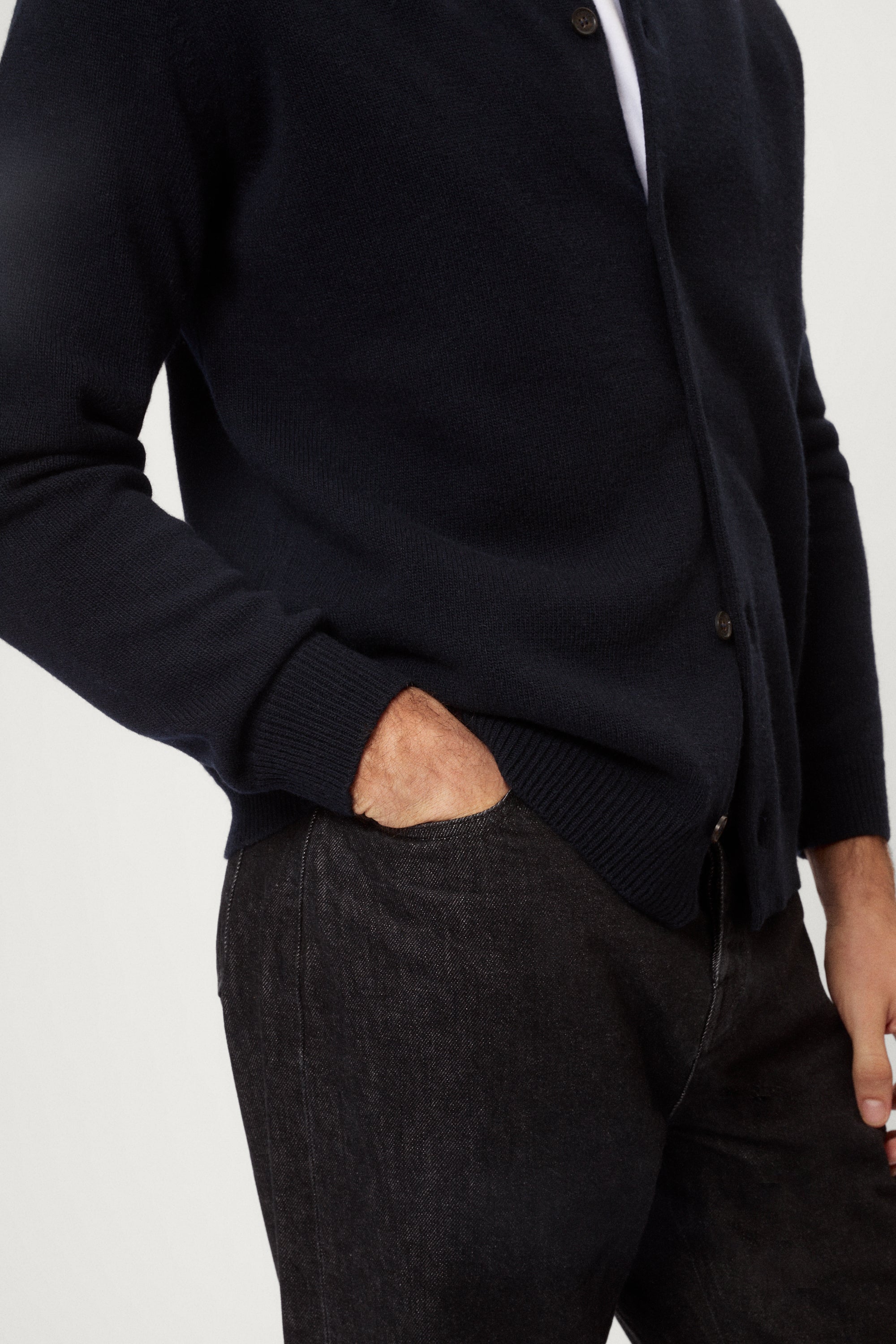 Man wearing a blue wool shirt over a white shirt with a plain background