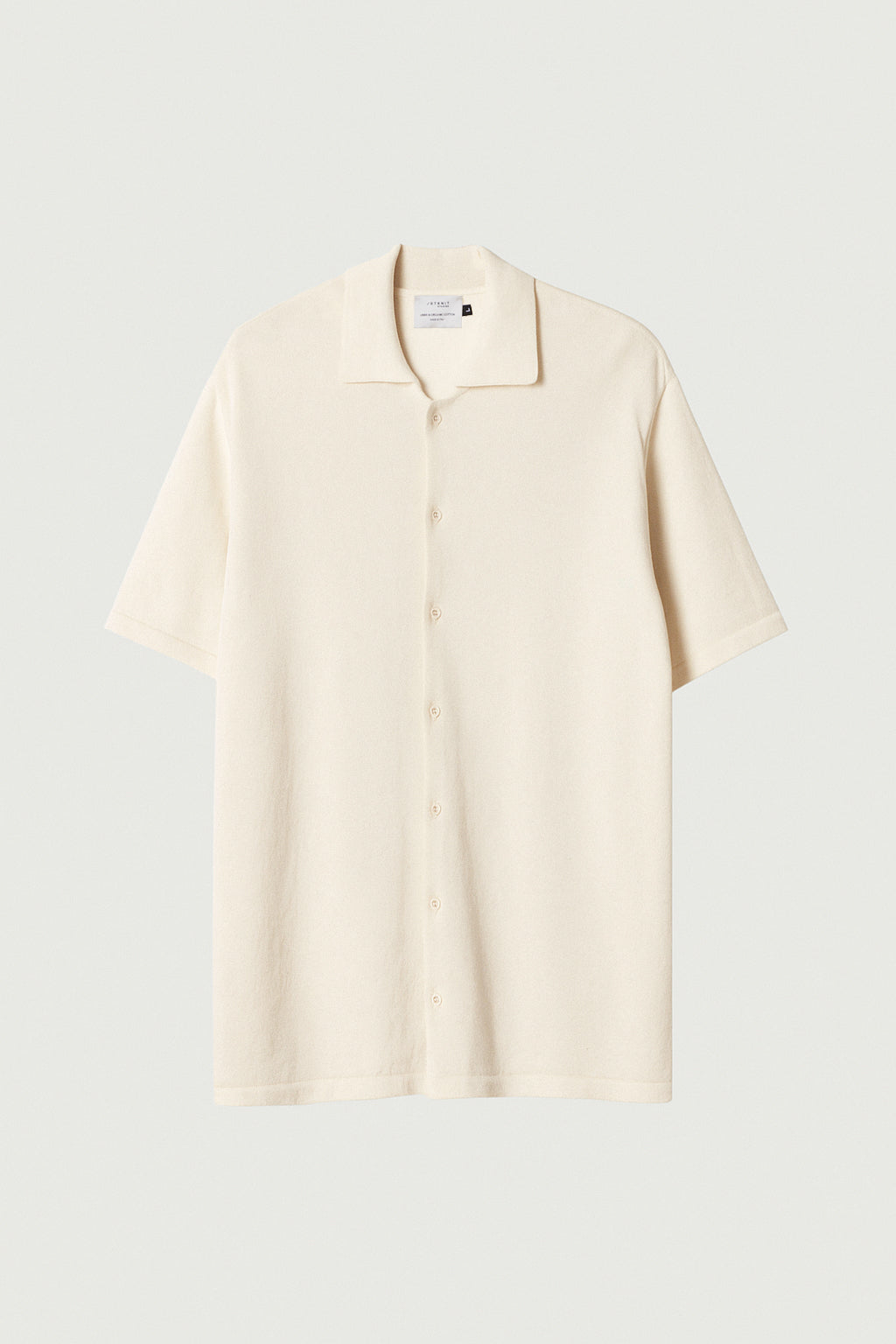 white polo shirt on a light gray background