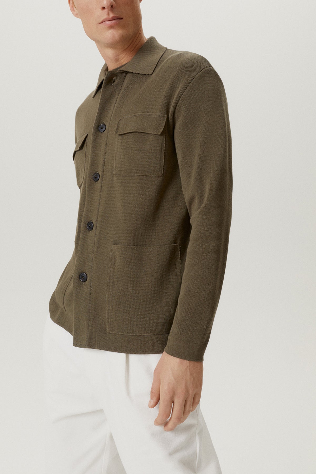 Man wearing a green jacket on a white background