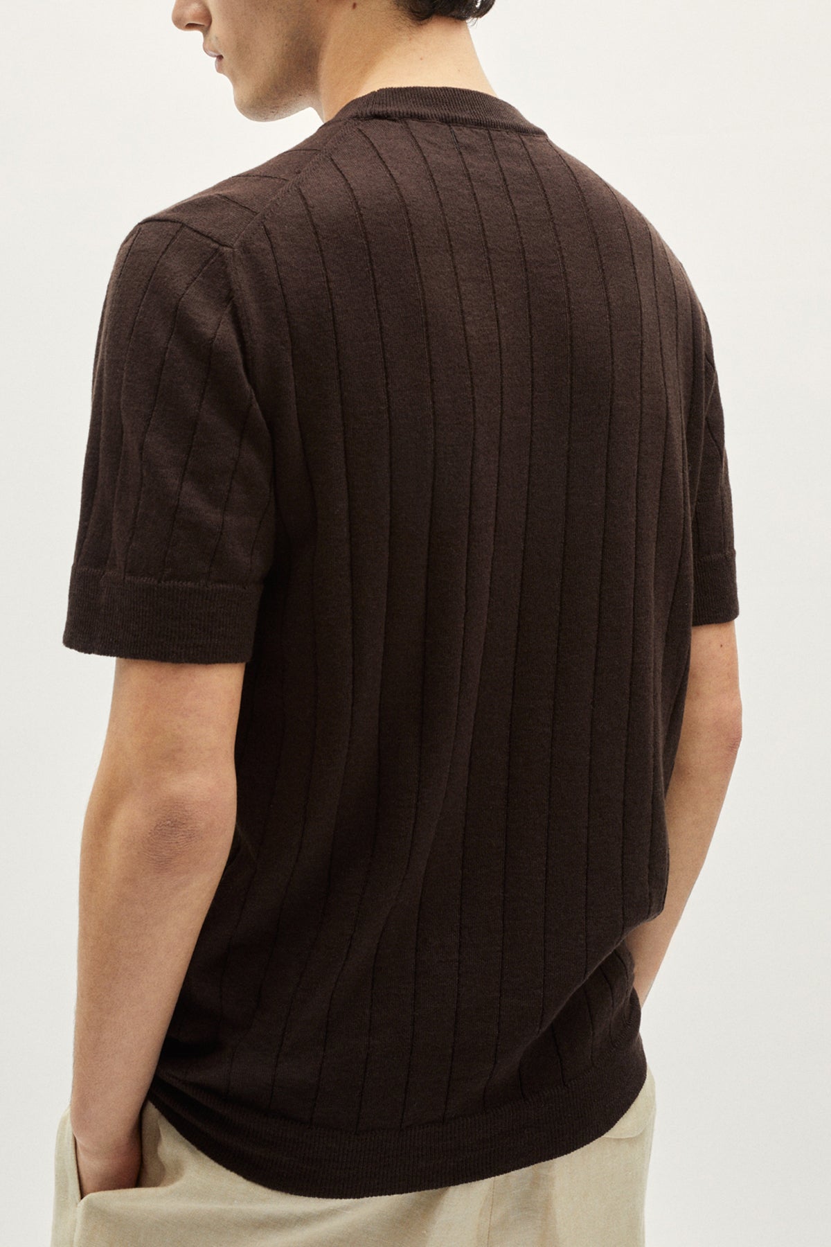 Man wearing a brown textured shirt on a white background