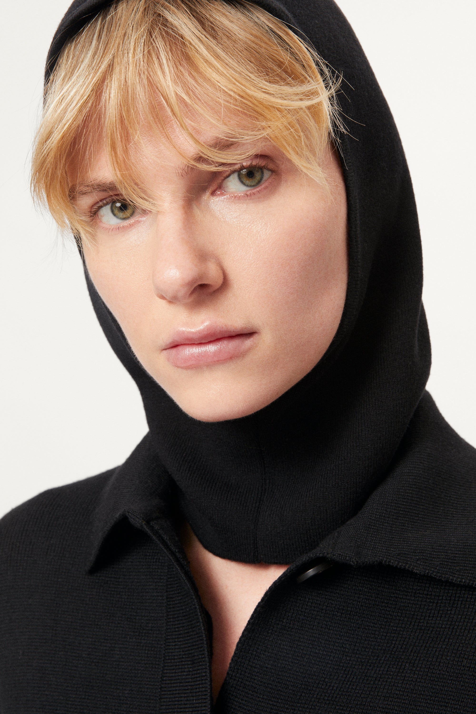 woman wearing a black ultrasoft miniclava against a white background