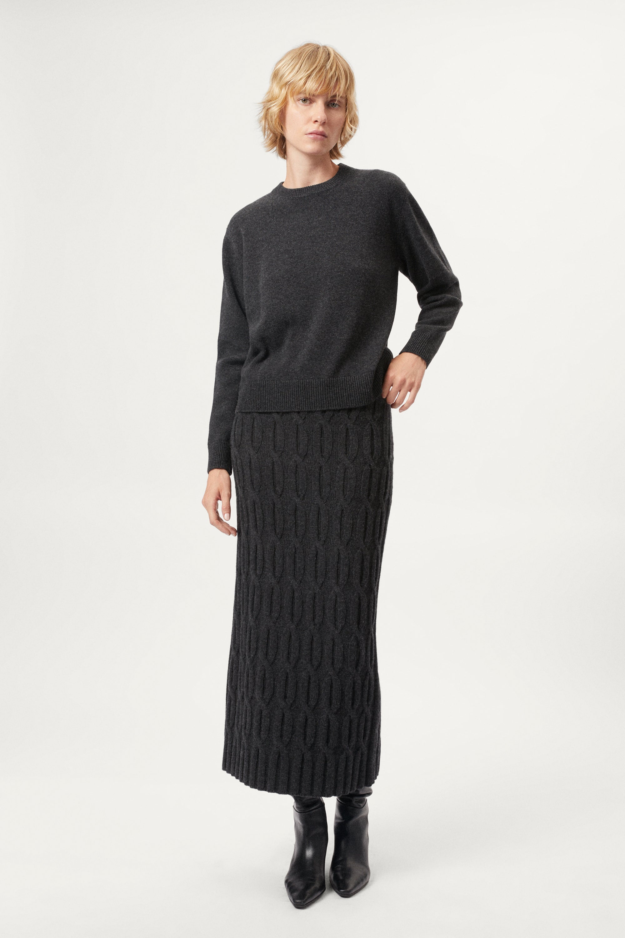 woman wearing a dark grey Woolen Cable knit skirt