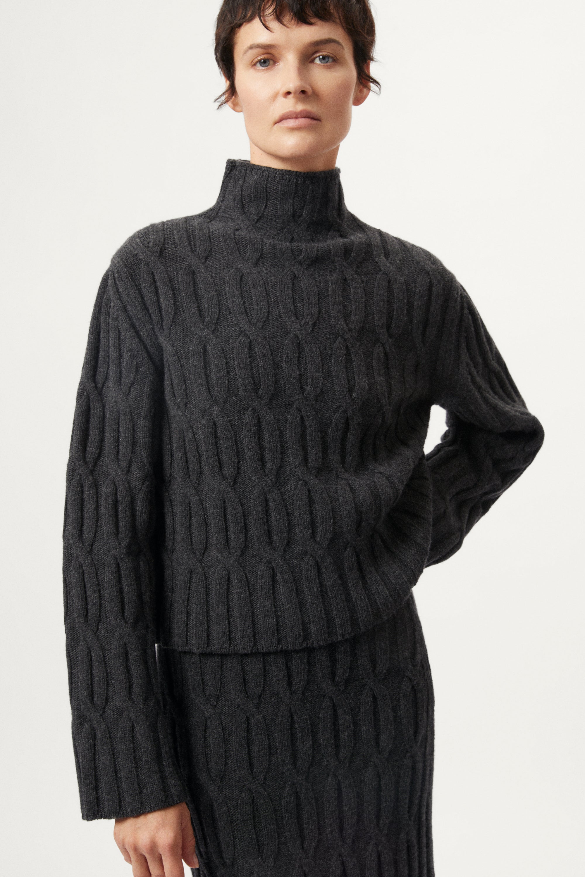 The Woolen Cable Knit Cropped High Neck - dark grey
