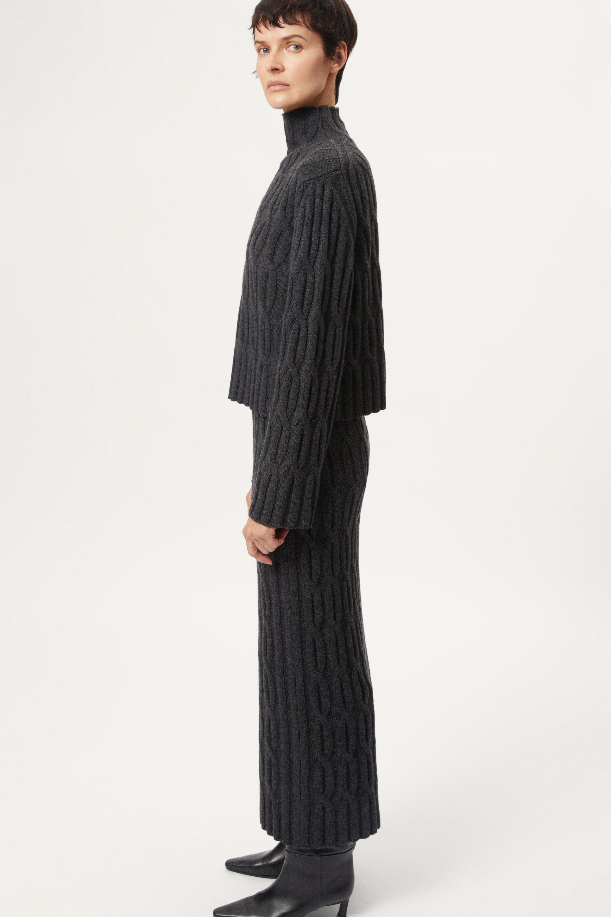 The Woolen Cable Knit Cropped High Neck - dark grey