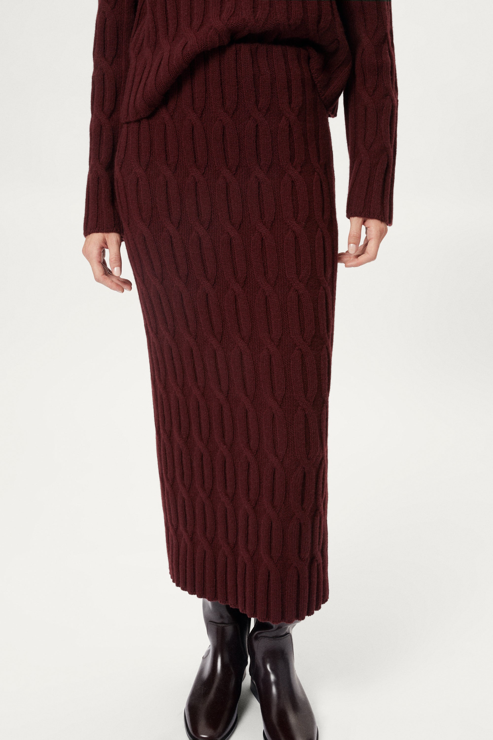 woman wearing a burgundy Woolen Cable knit skirt