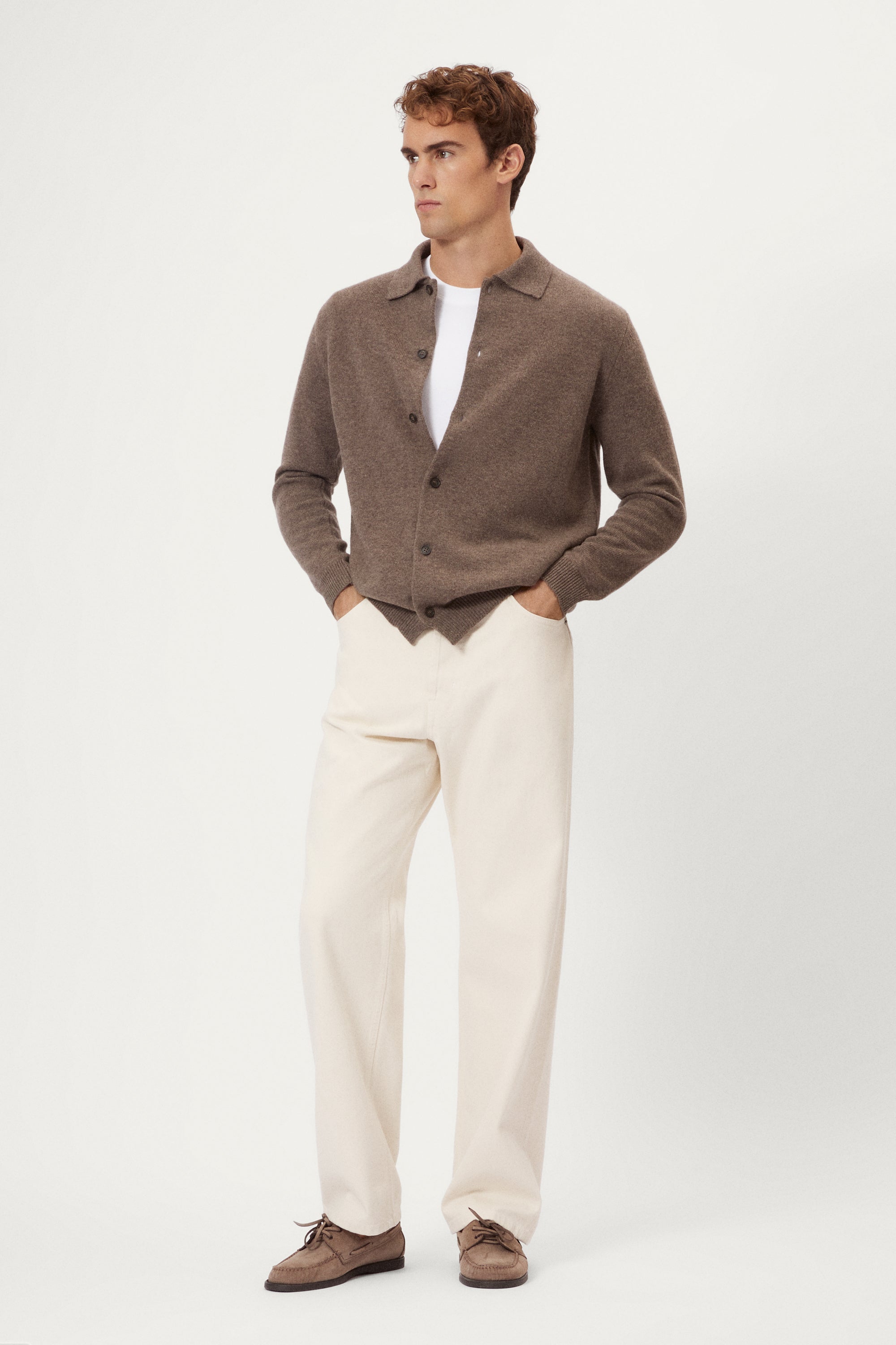 Man wearing a brown woolen polo shirt on a white background