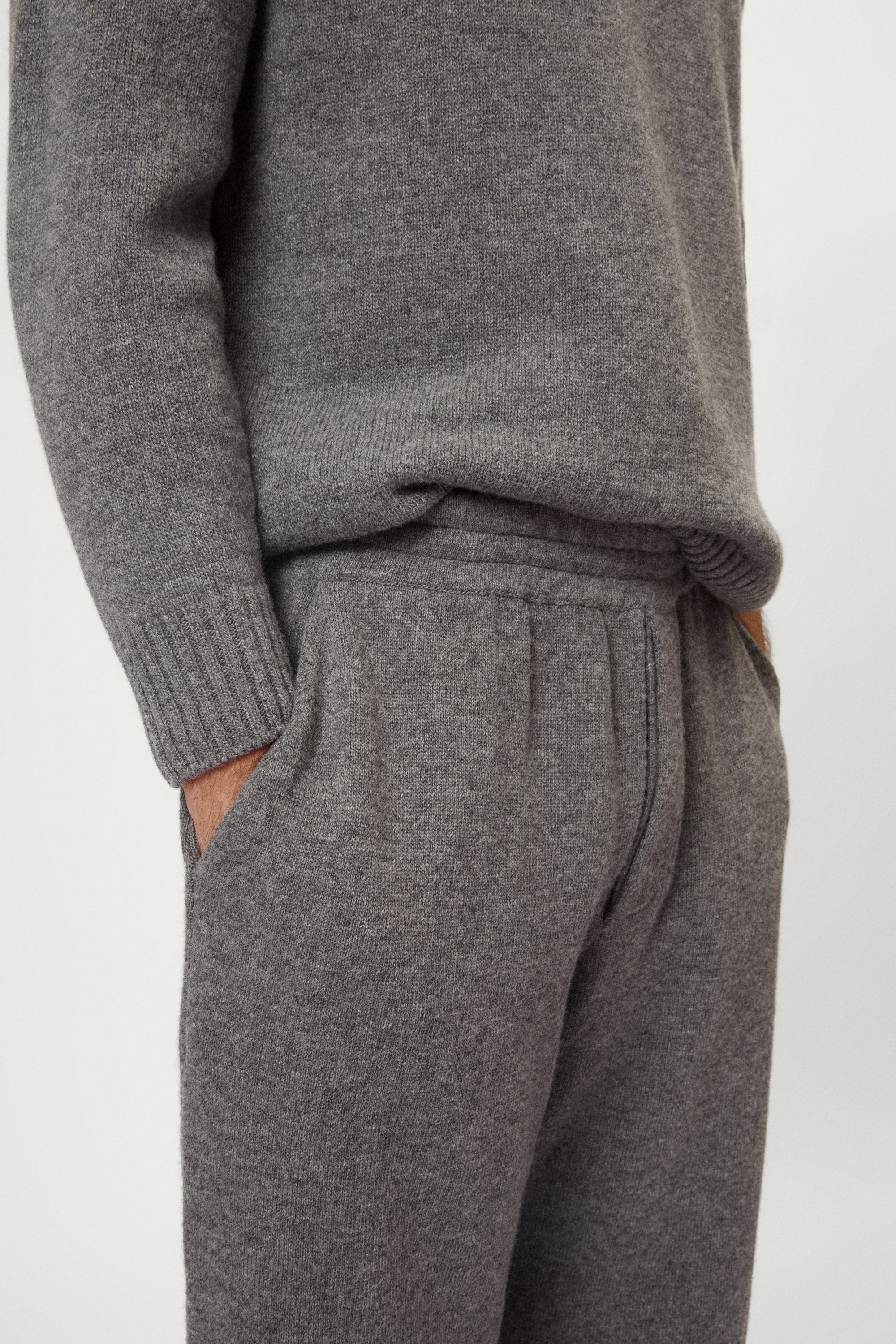 Gray sweater and pants set on a white background