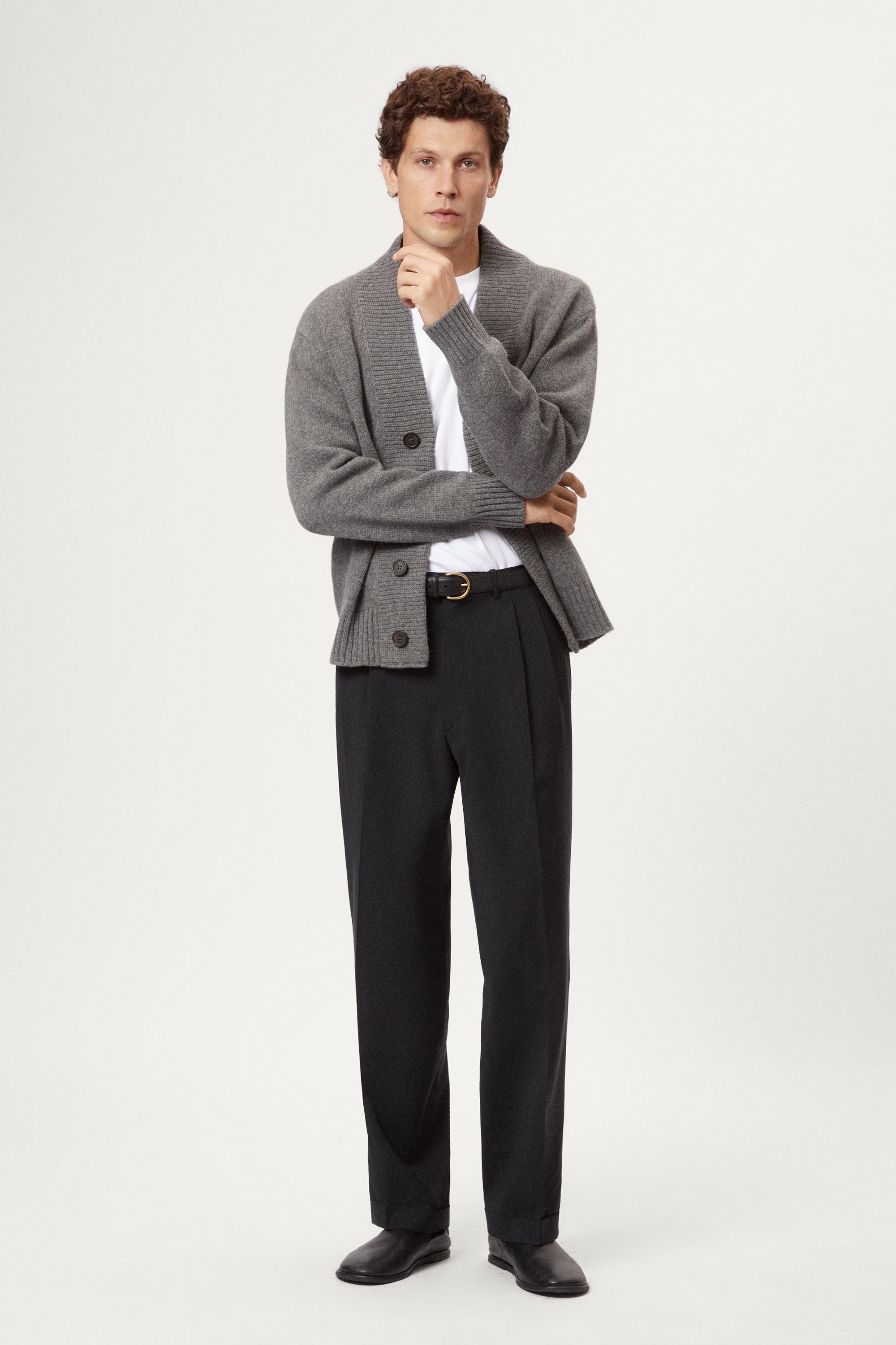 Man wearing a light gray Woolen Boxy Cardigan over a white shirt on a light gray background