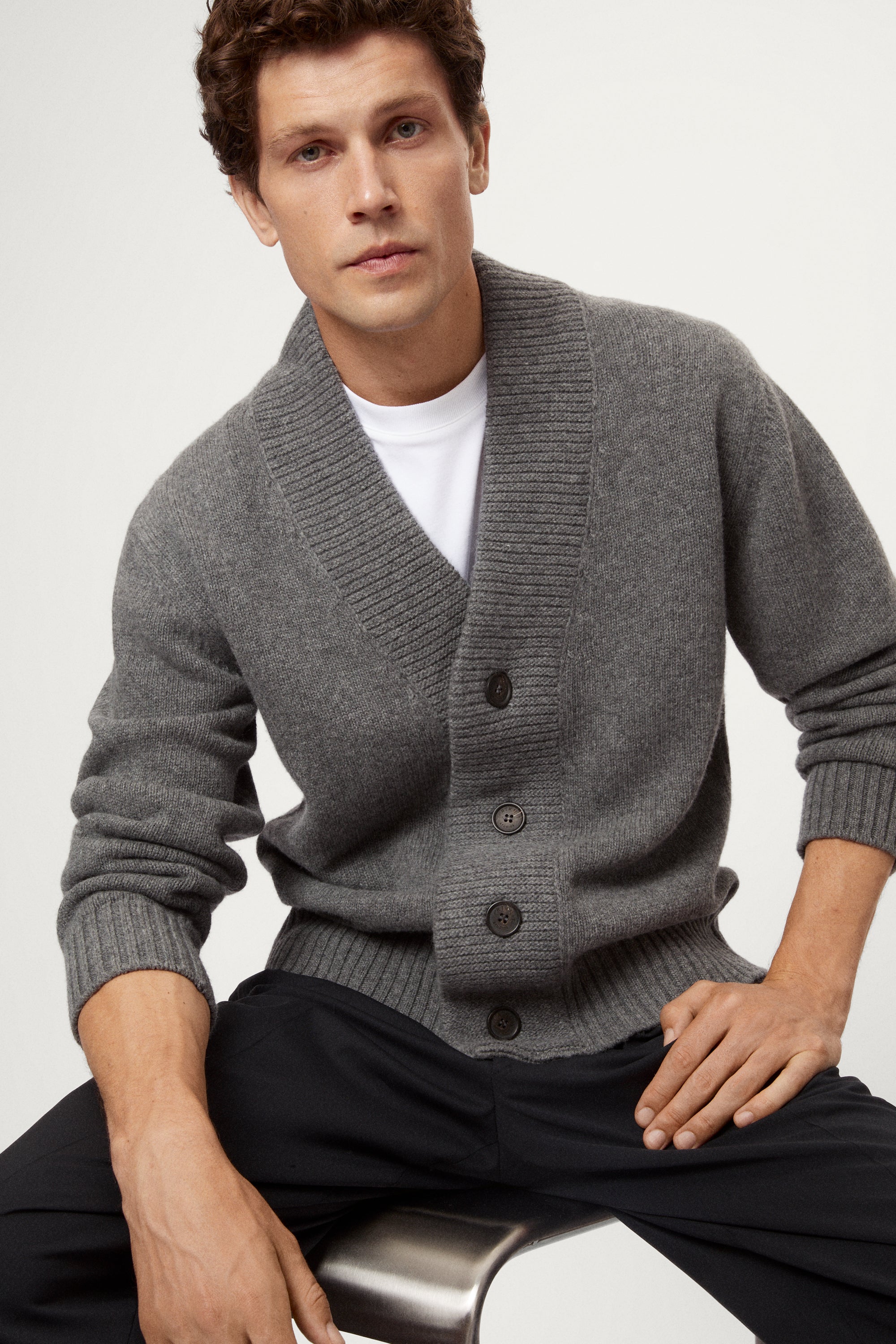 Man wearing a light gray Woolen Boxy Cardigan over a white shirt on a light gray background