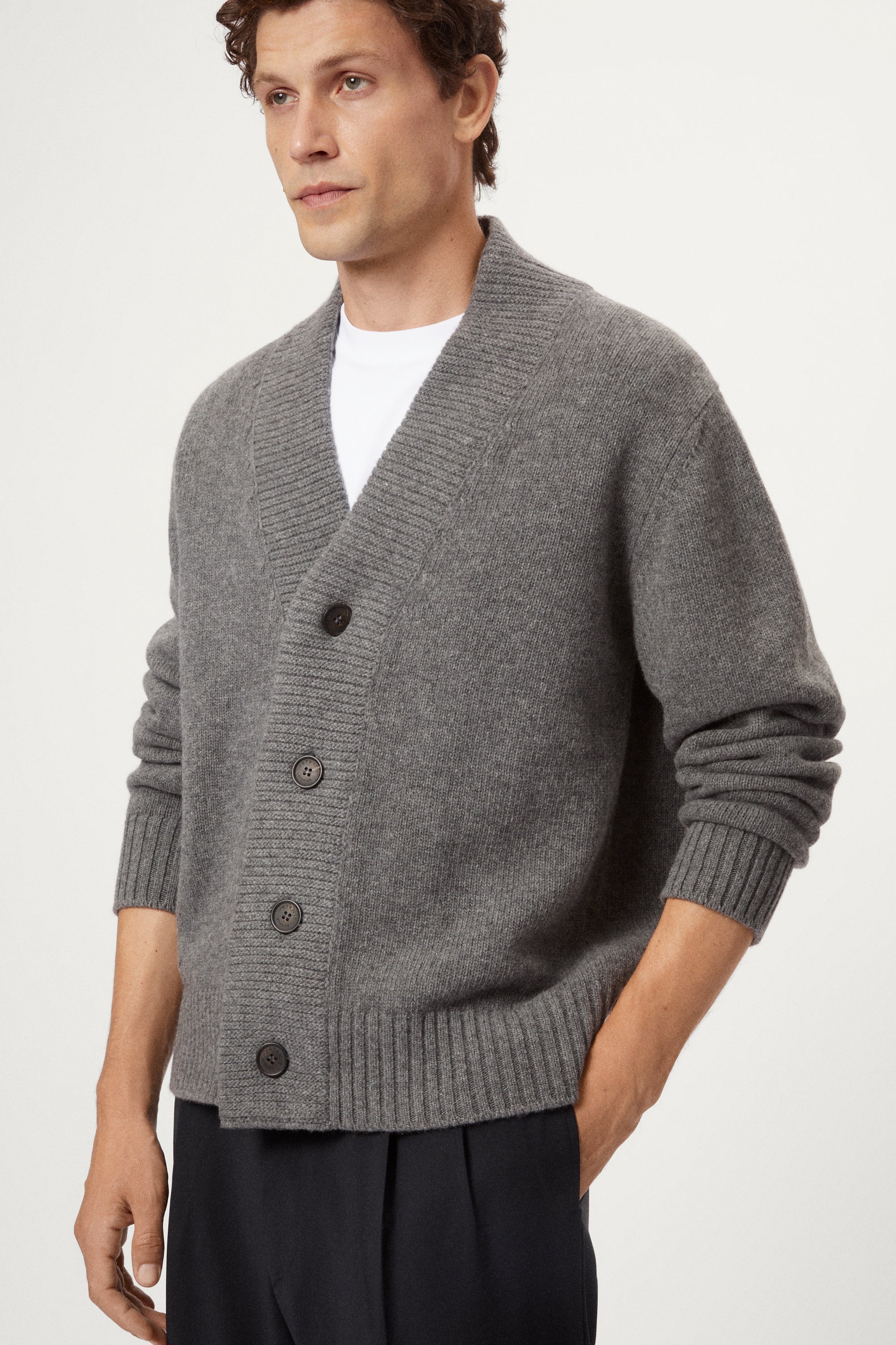 Man wearing a light gray Woolen Boxy Cardigan over a white shirt on a light gray background