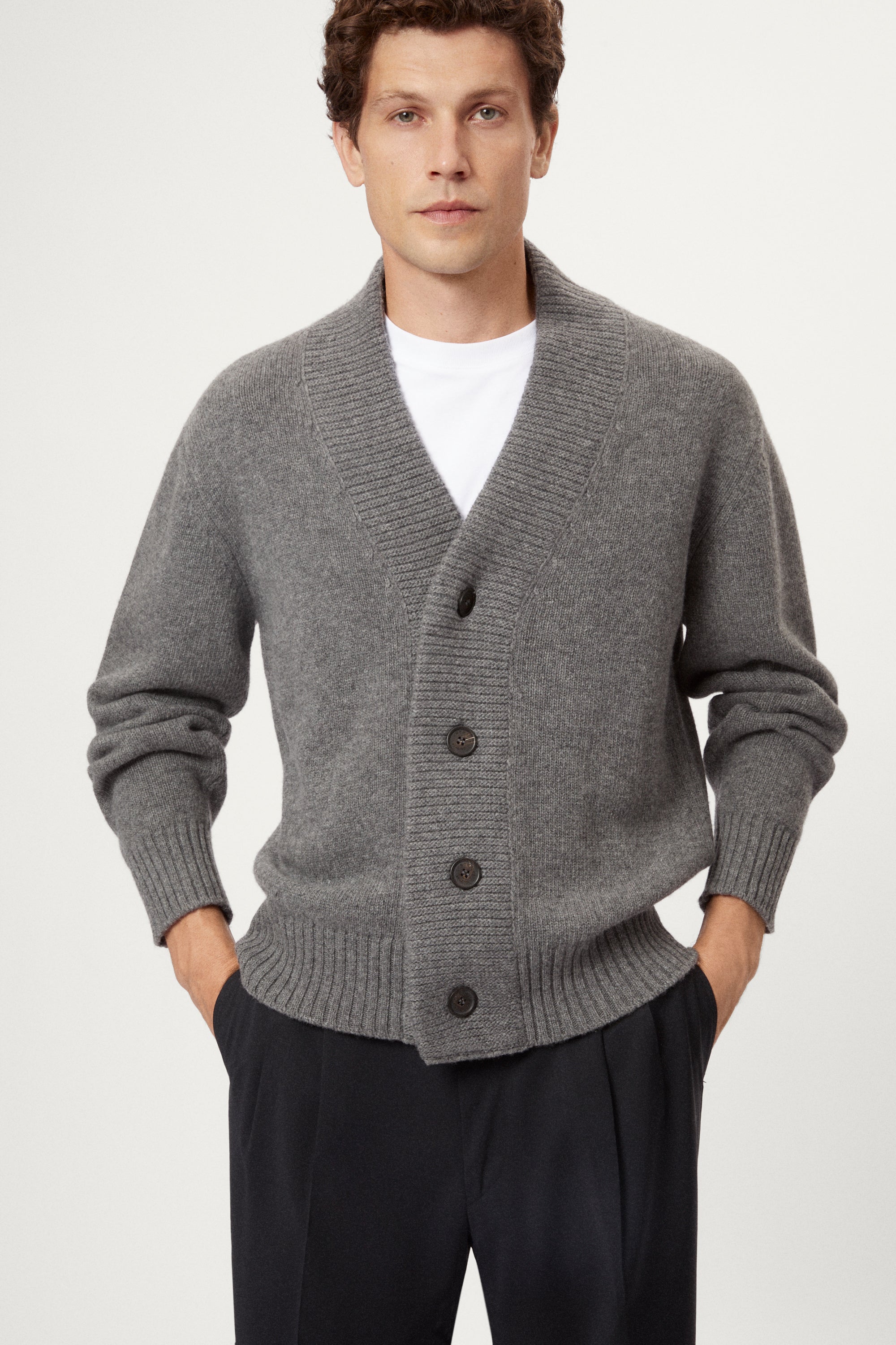 Man wearing a light gray Woolen Boxy Cardigan over a white shirt on a light gray background