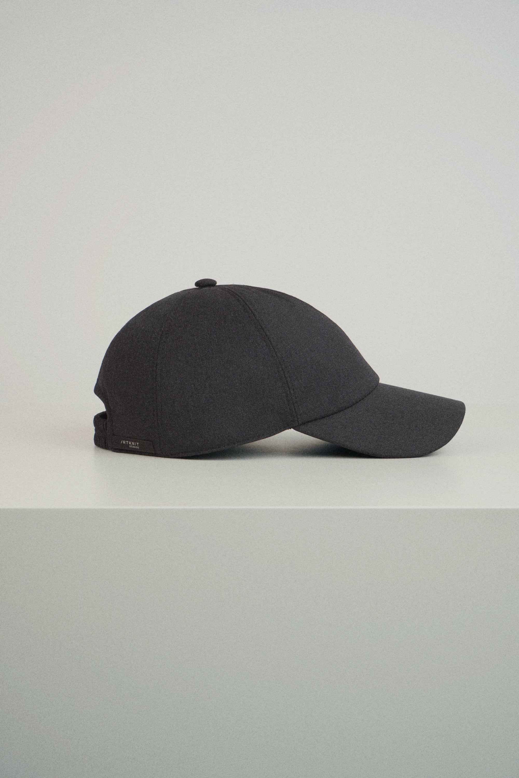 grey baseball cap on a light gray background